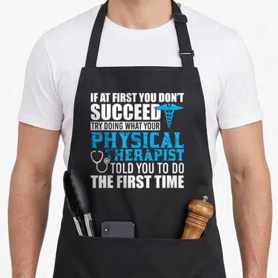 Motivational patient apron - Stacked text with blue caduceus and white stethoscope on black bib apron — shown on a black cotton canvas apron against a white background