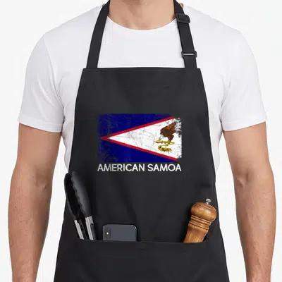 Samoan american flag apron - Distressed American Samoa flag with eagle and text on front panel — shown on a black cotton canvas apron against a white background