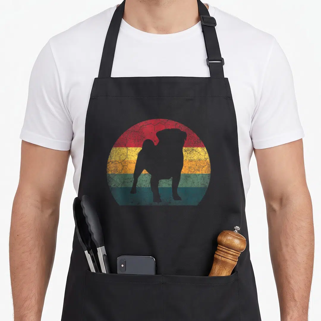 Pug distressed dog apron - White dog silhouette over red yellow orange green blue striped semi-circle with distressed — shown on a black cotton canvas apron against a white background