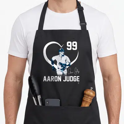 Judge fanprint apron - Baseball player inside white heart outline with number 99 and name AARON JUDGE in navy blue — shown on a black cotton canvas apron against a white background