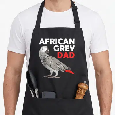 Parrot congo bird apron - Cartoon African Grey parrot with red tail and stacked text reading African Grey Dad — shown on a black cotton canvas apron against a white background