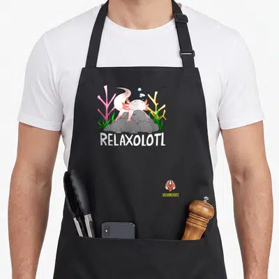 Relaxolotl rock candy apron - Cartoon axolotl lying on grey rock with pink coral, green seaweed, and white RELAXOLOTL — shown on a black cotton canvas apron against a white background