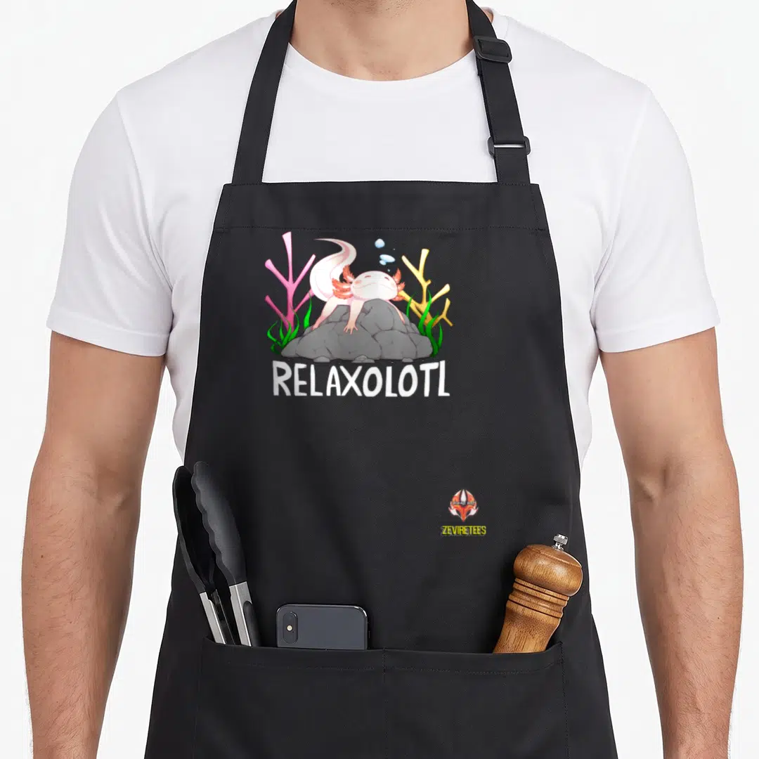 Relaxolotl rock candy apron - Cartoon axolotl lying on grey rock with pink coral, green seaweed, and white RELAXOLOTL — shown on a black cotton canvas apron against a white background