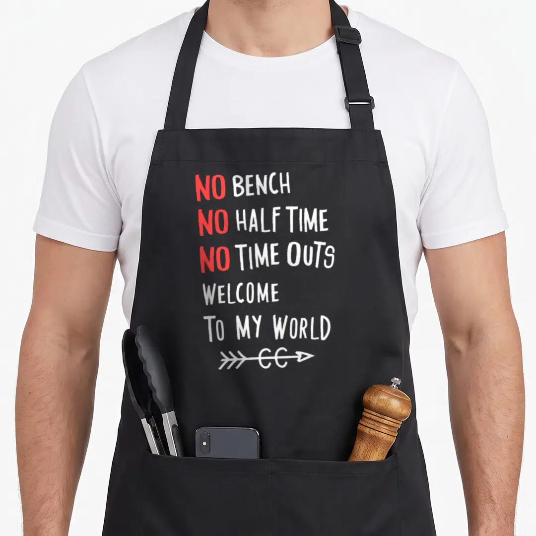 Bench country apron - Stacked red and white text no bench no half time with arrow graphic — shown on a black cotton canvas apron against a white background
