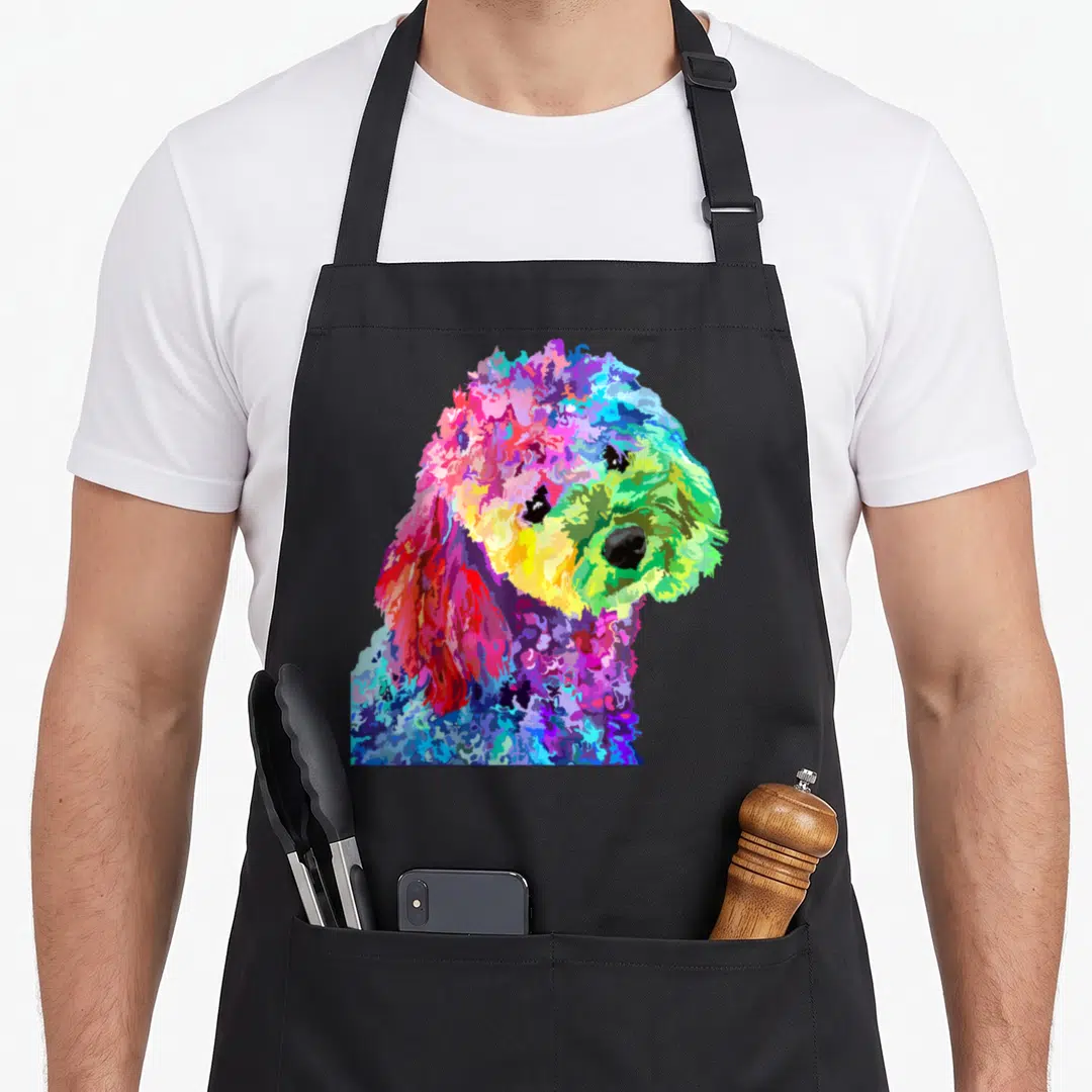 Colorful poodle dog apron - Rainbow cartoon poodle head and shoulders in pink blue yellow green purple — shown on a black cotton canvas apron against a white background