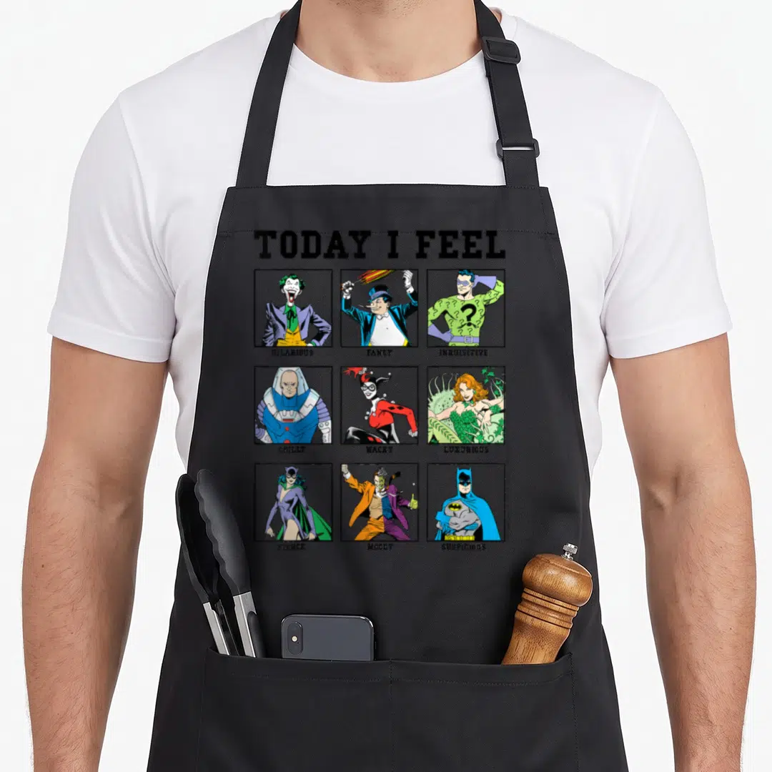Villain box apron - TODAY I FEEL grid with nine comic characters labeled HILARIOUS FANCY INQUISITIVE CHILLY WACKY — shown on a black cotton canvas apron against a white background