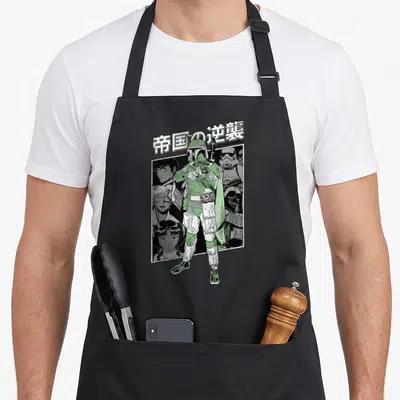 Kanji anime apron - Boba Fett manga illustration with Japanese text The Empire Strikes Back and STAR WARS logo in green — shown on a black cotton canvas apron against a white background