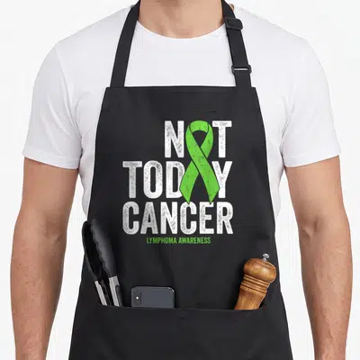 Hodgkin lime green apron - Distressed white Not Today Cancer text with vertical lime green ribbon and Lymphoma — shown on a black cotton canvas apron against a white background