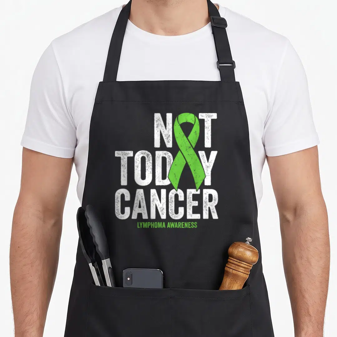 Hodgkin lime green apron - Distressed white Not Today Cancer text with vertical lime green ribbon and Lymphoma — shown on a black cotton canvas apron against a white background