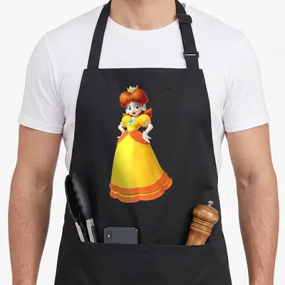 Princess daisy apron - Cartoon Princess Daisy in yellow dress with orange sash and white gloves on black background — shown on a black cotton canvas apron against a white background