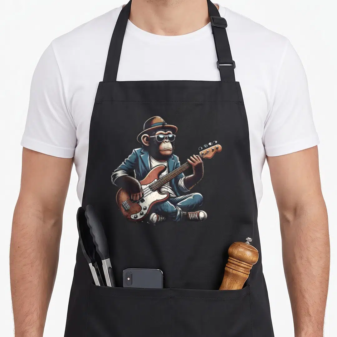 Chimpanzee funky apron - Cartoon chimpanzee in blue suit and hat playing electric bass guitar — shown on a black cotton canvas apron against a white background