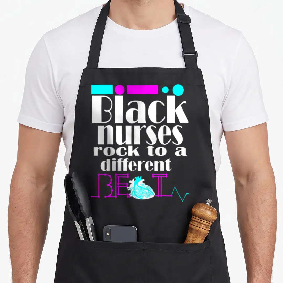 Afro nursing student apron - White text Black nurses rock different beat with cyan heart and EKG line — shown on a black cotton canvas apron against a white background