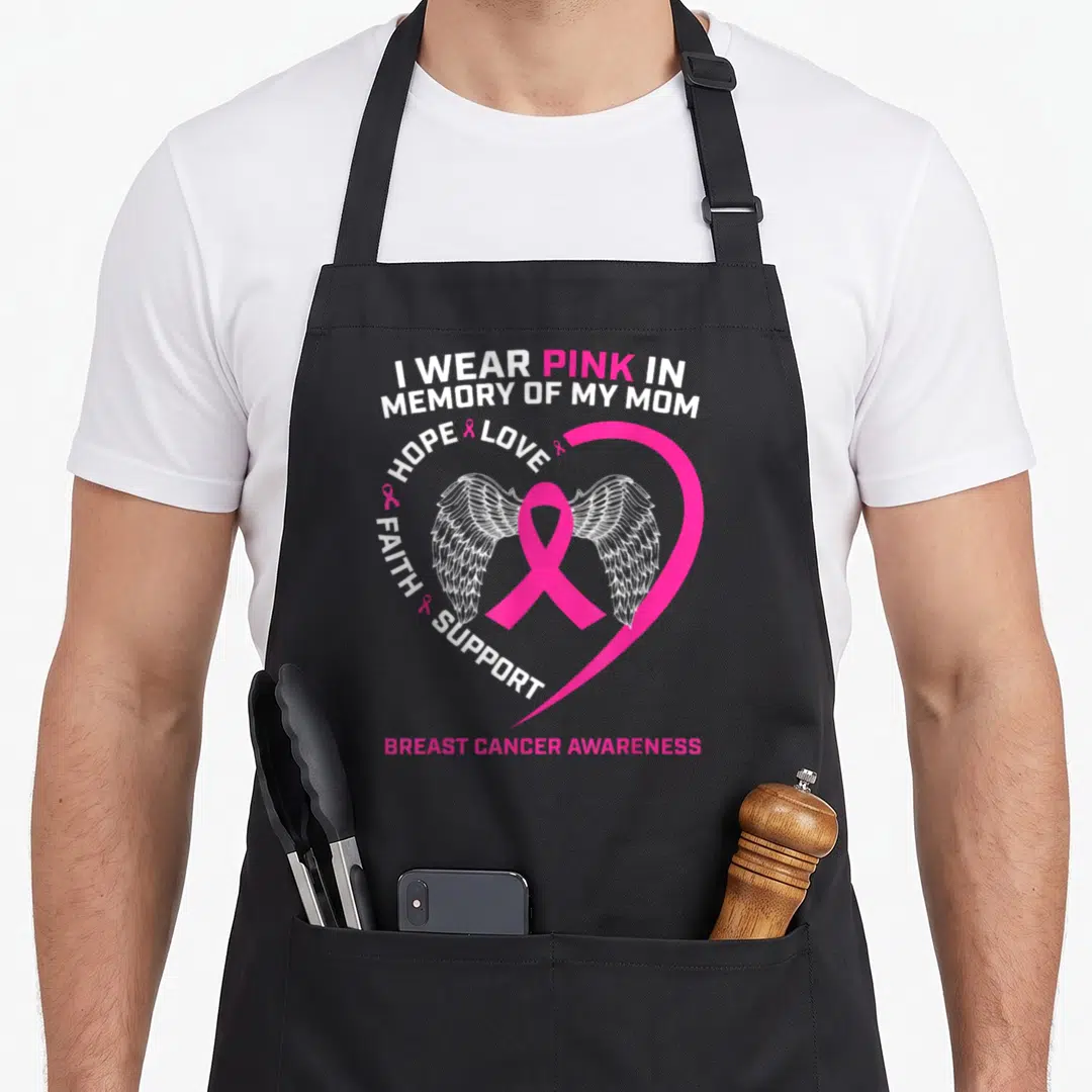 Memory breast cancer awareness aprons - Pink ribbon with white wings inside heart outline and memorial text — shown on a black cotton canvas apron against a white background