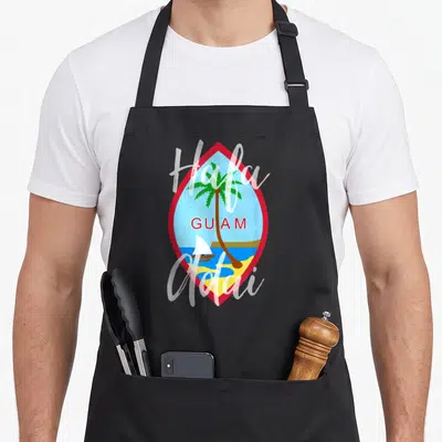 Cute hafa guam aprons - Red diamond frame with palm tree, sailboat, and Hafa Adai GUAM text — shown on a black cotton canvas apron against a white background