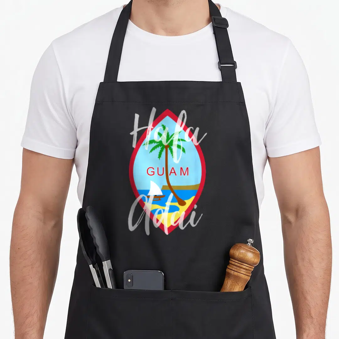 Cute hafa guam aprons - Red diamond frame with palm tree, sailboat, and Hafa Adai GUAM text — shown on a black cotton canvas apron against a white background