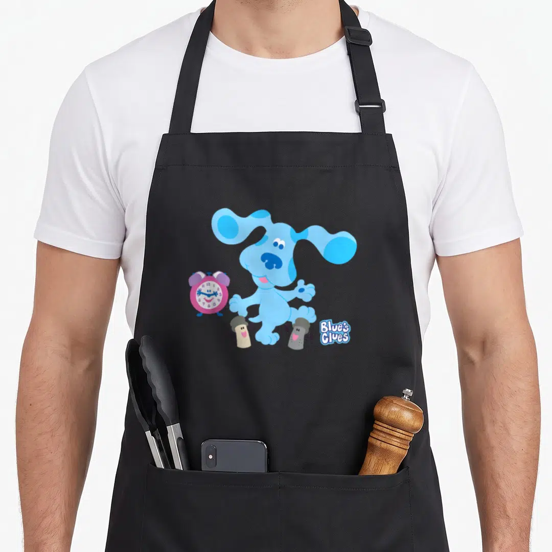 Blue clue novelty apron - Blue dog, pink alarm clock, two thumbtacks, Blue's Clues text — shown on a black cotton canvas apron against a white background