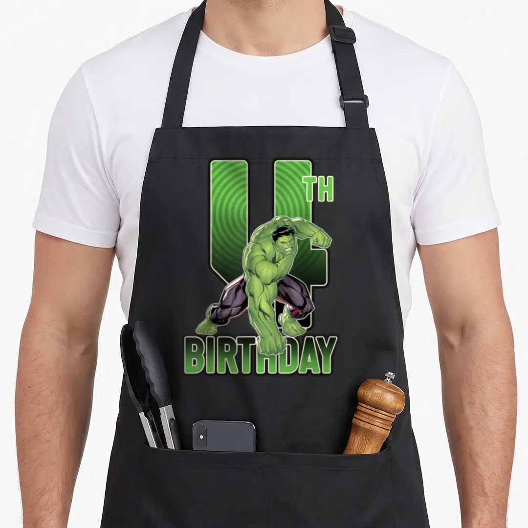 4th birthday apron - Hulk crouching in front of green number 4 with TH BIRTHDAY text below — shown on a black cotton canvas apron against a white background