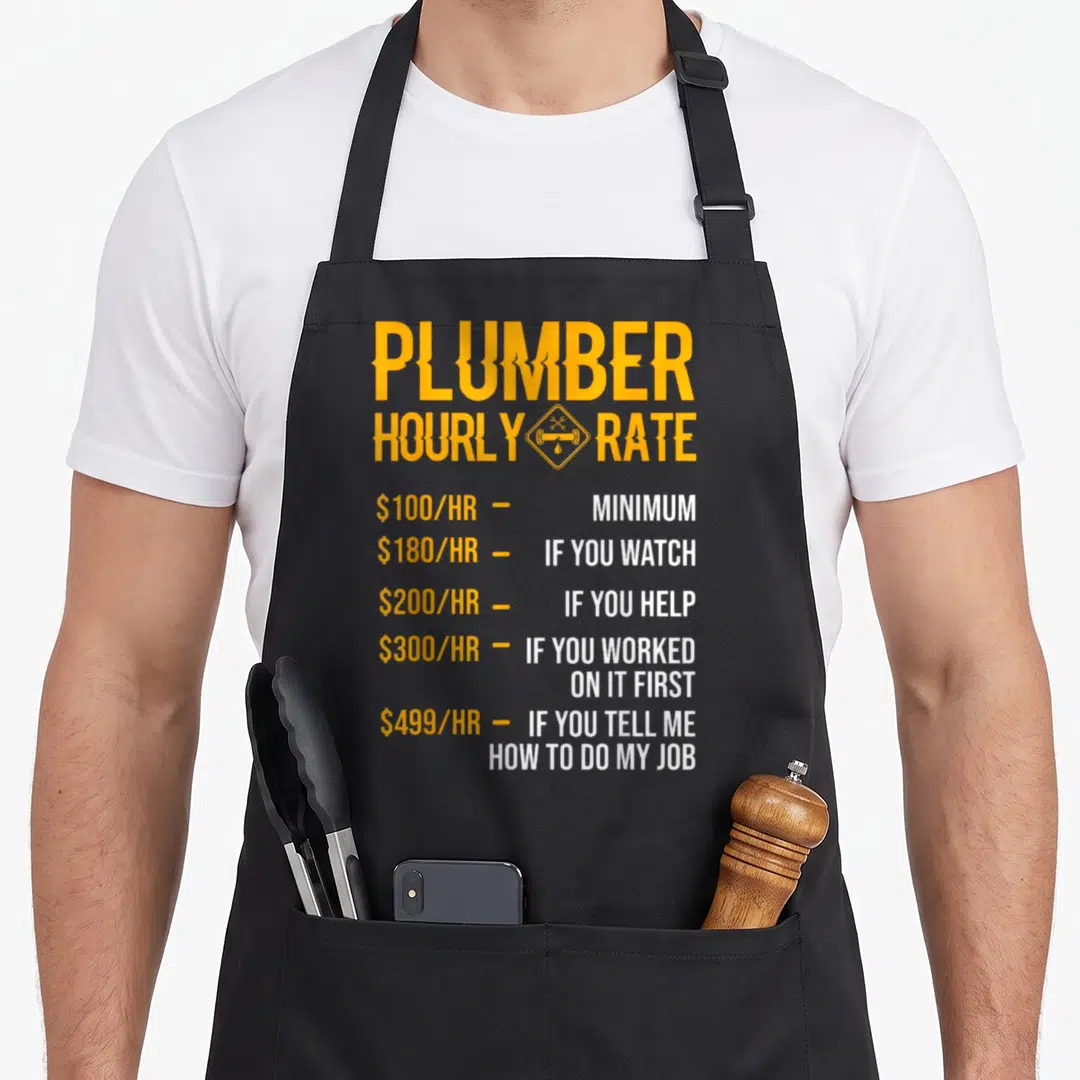 Hourly plumber apron - Yellow PLUMBER HOURLY RATE list with prices $100 to $499 and wrench icon — shown on a black cotton canvas apron against a white background