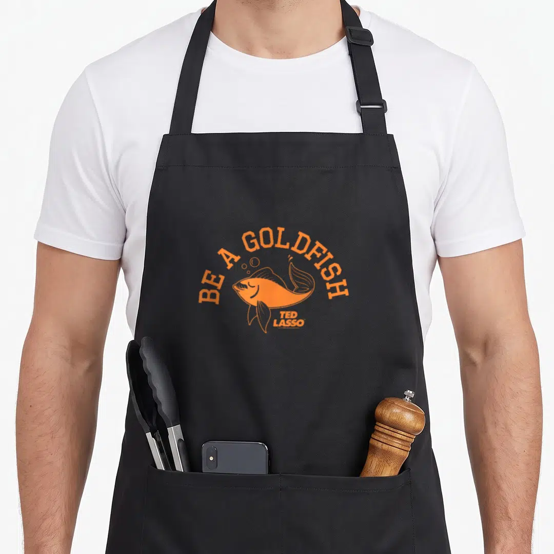 Goldfish collegiate aprons - Orange cartoon goldfish with arched text and three bubbles on black fabric — shown on a black cotton canvas apron against a white background