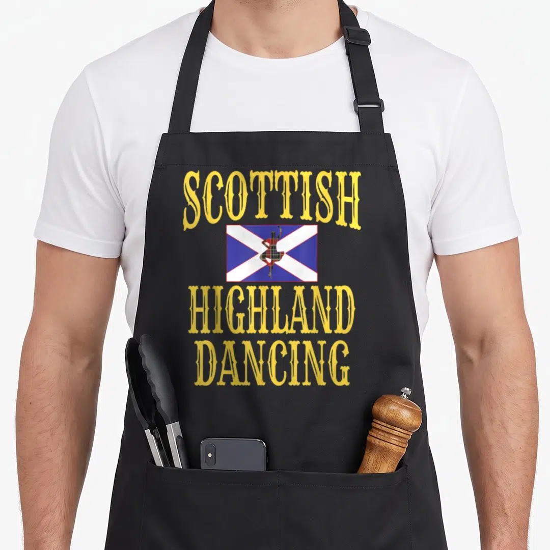 Dance game aprons - Arched yellow text SCOTTISH HIGHLAND DANCING surrounding a plaid dancer on a blue and white saltire — shown on a black cotton canvas apron against a white background