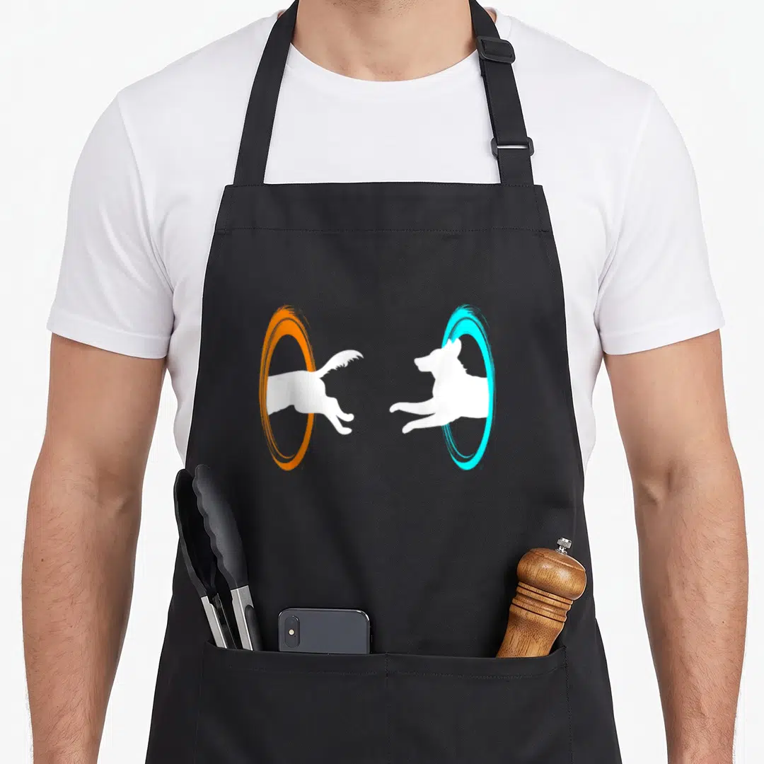 Dimensional dog apron - White cartoon dog jumping through orange and cyan circular portals — shown on a black cotton canvas apron against a white background