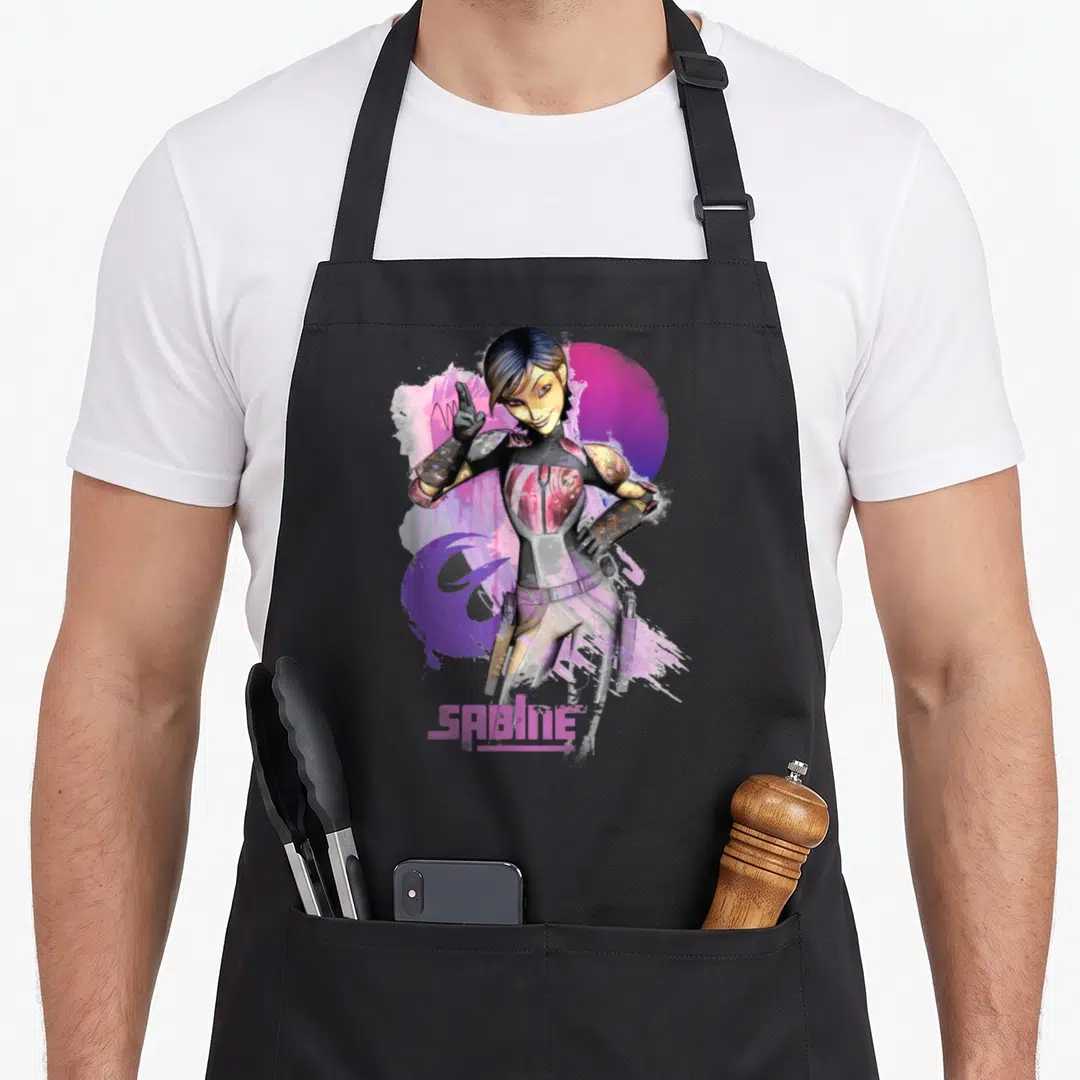 Sabine wars classic apron - Cartoon Sabine Wren over pink purple watercolor with SABINE text at bottom — shown on a black cotton canvas apron against a white background