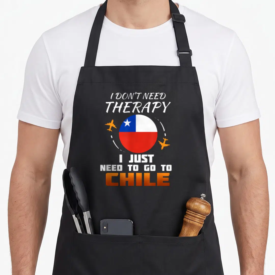 Chile chilean apron - I Don't Need Therapy I Just Need To Go To Chile text with circular flag and two planes — shown on a black cotton canvas apron against a white background