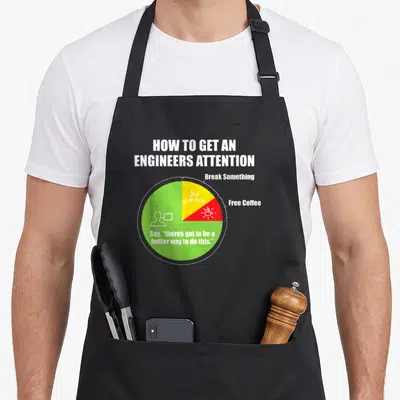 Attention engineer apron - Pie chart with white green yellow red sections showing how to get an engineers attention via — shown on a black cotton canvas apron against a white background