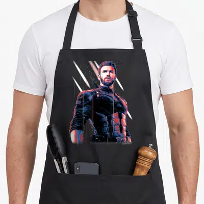 Pose infinity apron - Captain America photo art with blue red white diagonal streaks on black bib — shown on a black cotton canvas apron against a white background