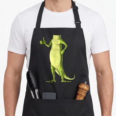 Gecko body apron - Headless green lizard humanoid standing and giving a thumbs up in cartoon style — shown on a black cotton canvas apron against a white background