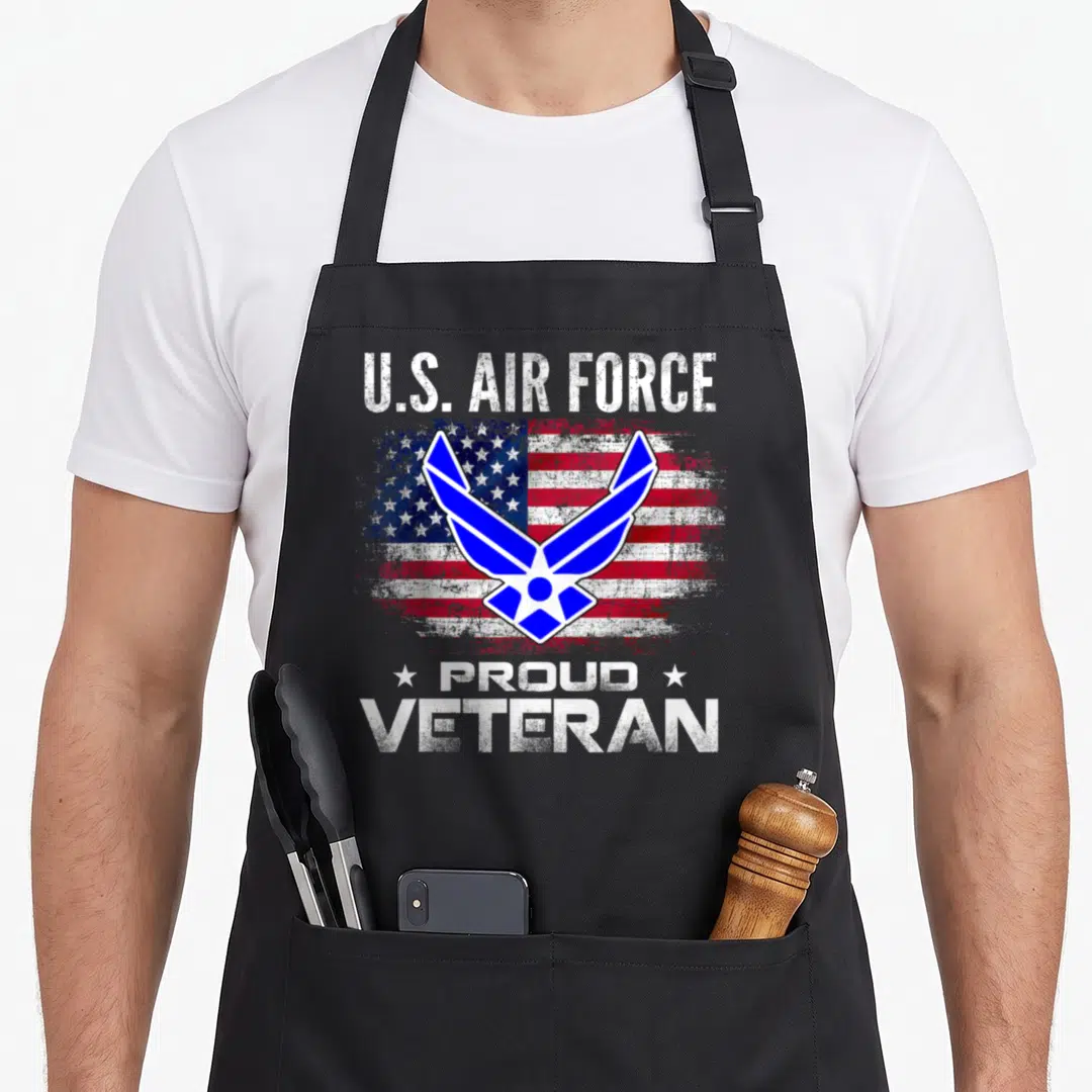 Air american flag apron - U.S. Air Force symbol over distressed flag with Proud Veteran text and stars — shown on a black cotton canvas apron against a white background
