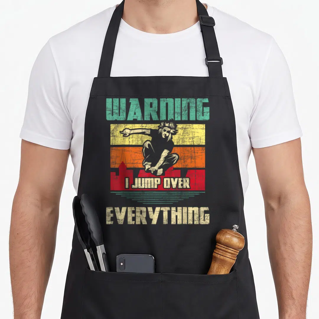 Jump parkour apron - Retro tracer figure jumping over red skyline with warning text on colored stripes — shown on a black cotton canvas apron against a white background