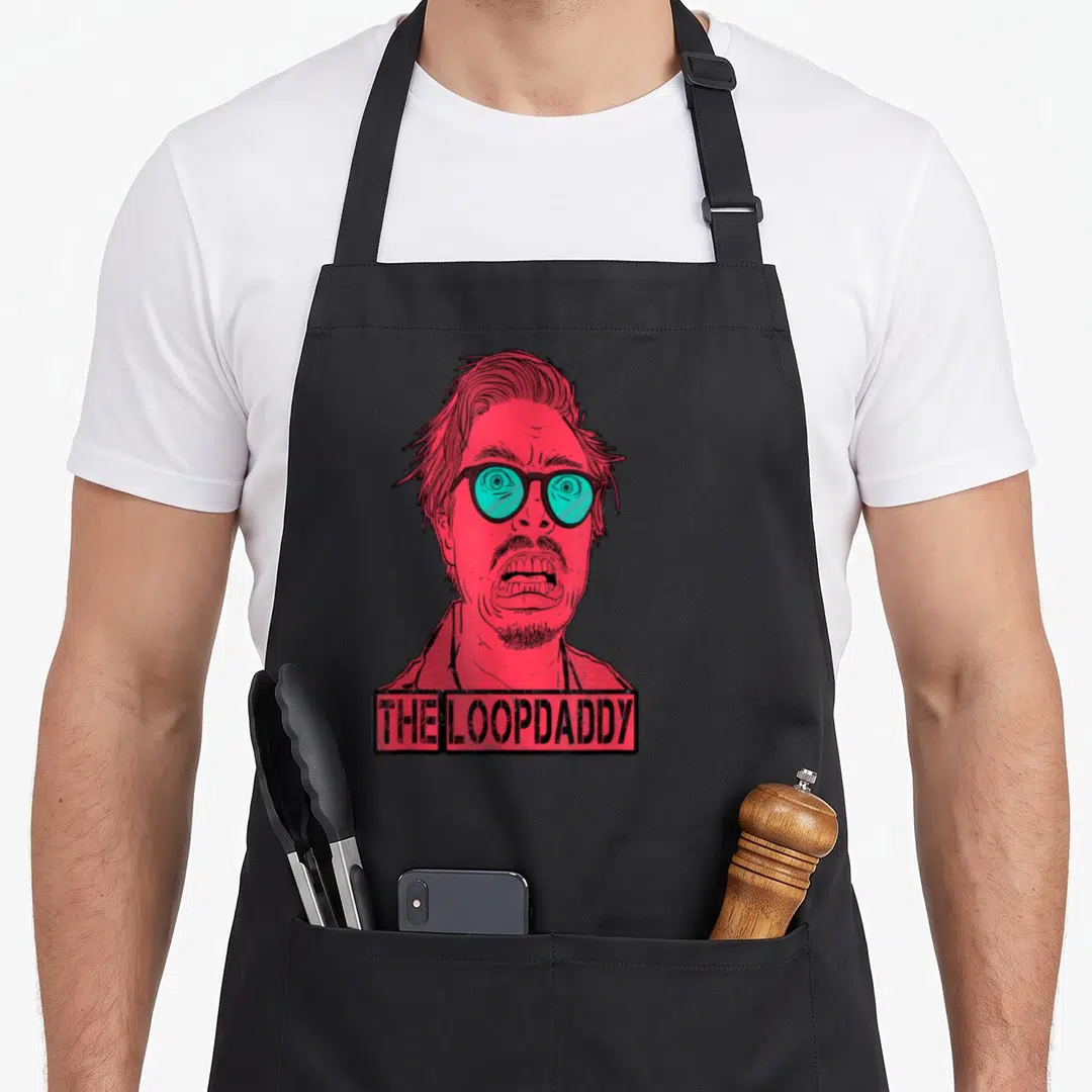 Jazz funky apron - Red line art man with teal glasses above THE LOOPDADDY text box — shown on a black cotton canvas apron against a white background