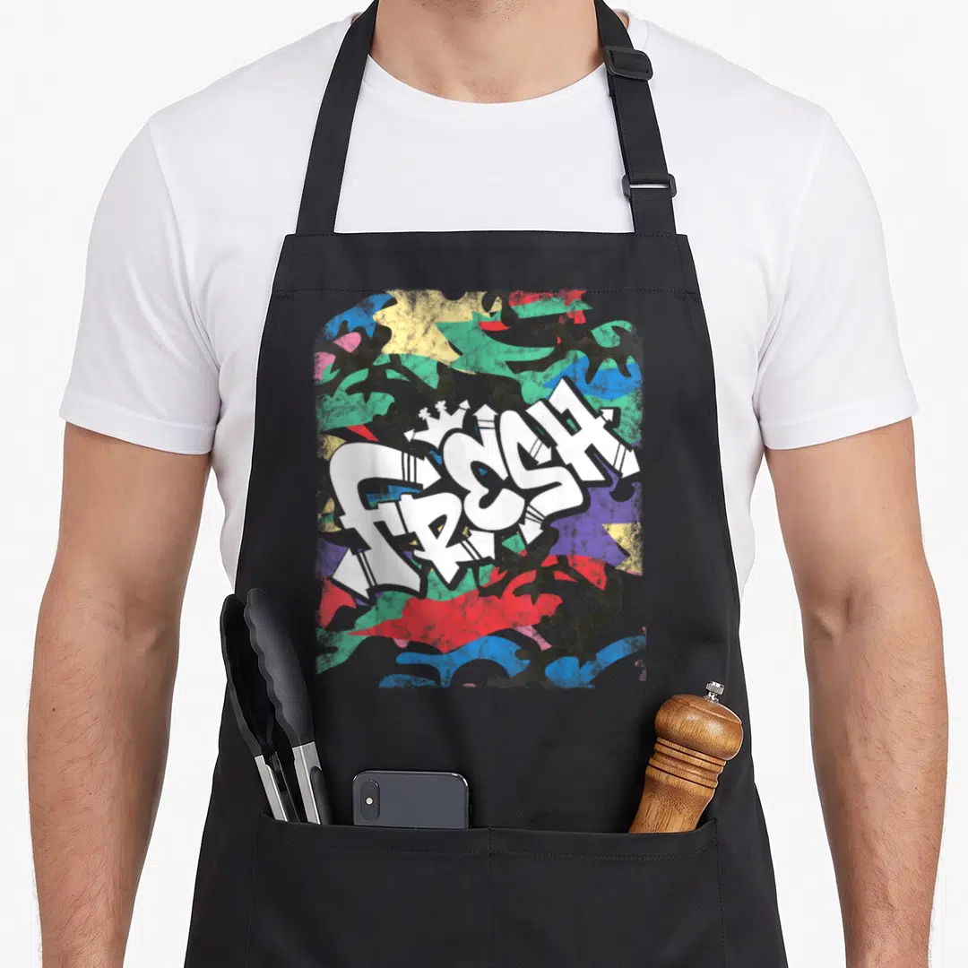 Hip urban apron - White FRESH graffiti text with crown over blue green red yellow black camouflage pattern — shown on a black cotton canvas apron against a white background
