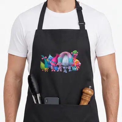 Troll friends apron - Seven cartoon trolls with pink, blue, purple, and green hair standing side-by-side in a cluster — shown on a black cotton canvas apron against a white background