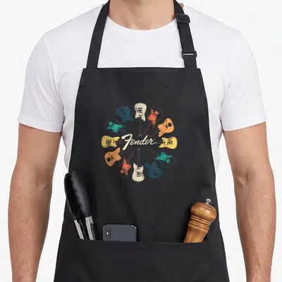 Kaleidoscope fender apron - Ten electric guitars in radial circle with Fender script in blue, orange, red, cream, white — shown on a black cotton canvas apron against a white background