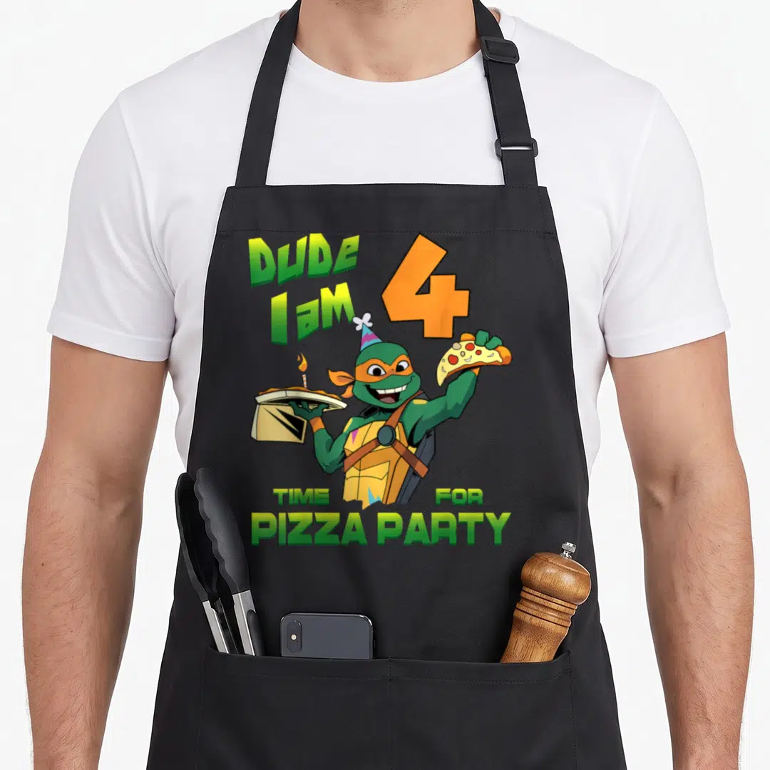 Mikey pizza apron - Cartoon turtle holding pizza box and slice with green and orange text celebrating age four — shown on a black cotton canvas apron against a white background