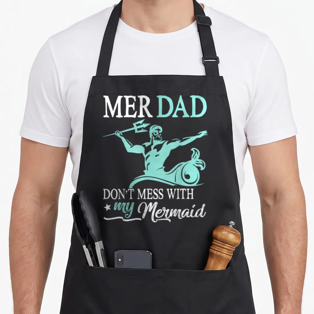 Mer father son apron - Teal merman with trident and text MER DAD Don't Mess With My Mermaid — shown on a black cotton canvas apron against a white background
