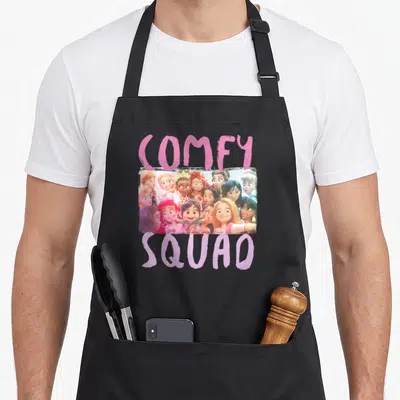 Wreck novelty apron - COMFY SQUAD text above cartoon group photo of women with pink hearts — shown on a black cotton canvas apron against a white background