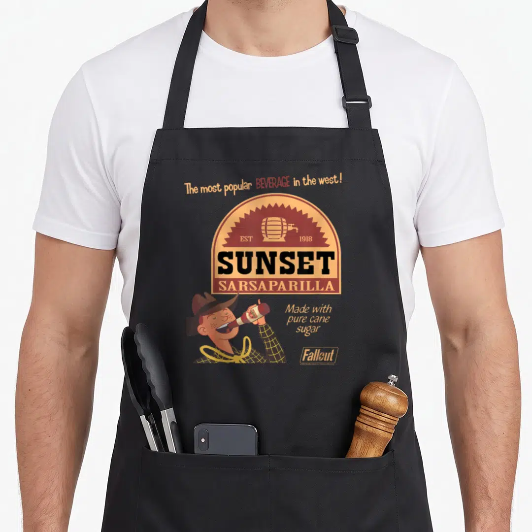 Sunset video game apron - Cartoon cowboy drinking Sunset Sarsaparilla bottle under vintage barrel logo with Fallout — shown on a black cotton canvas apron against a white background