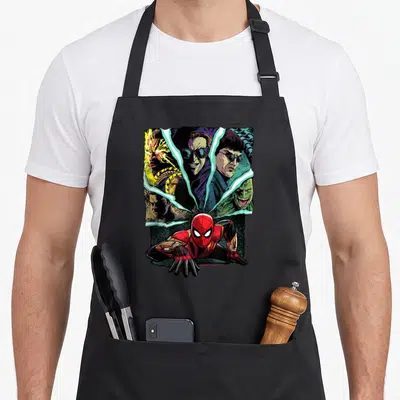 Way goblin apron - Spider-Man crouching in red suit with four villain faces in background shards of green, yellow — shown on a black cotton canvas apron against a white background