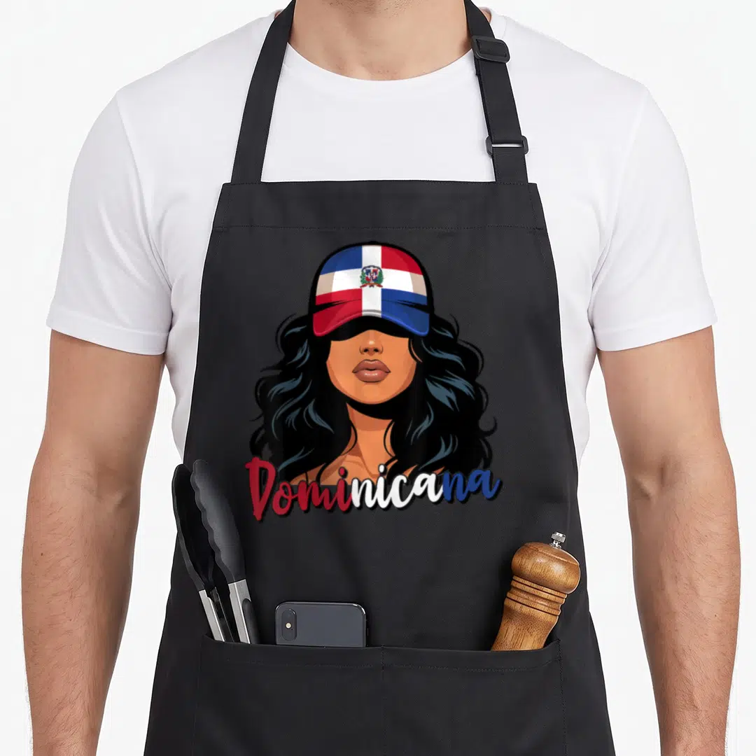 Proud dominican apron - Cartoon woman in red white blue flag cap with Dominicana script below — shown on a black cotton canvas apron against a white background