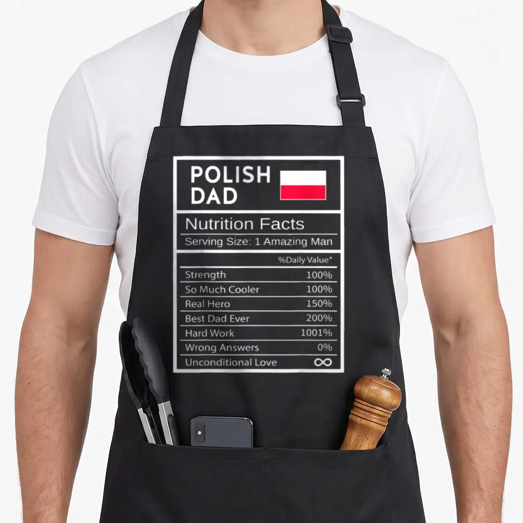 Nutrition polish kitchen aprons - Grey nutrition label reading Polish Dad with flag and values like 1001% Hard Work — shown on a black cotton canvas apron against a white background