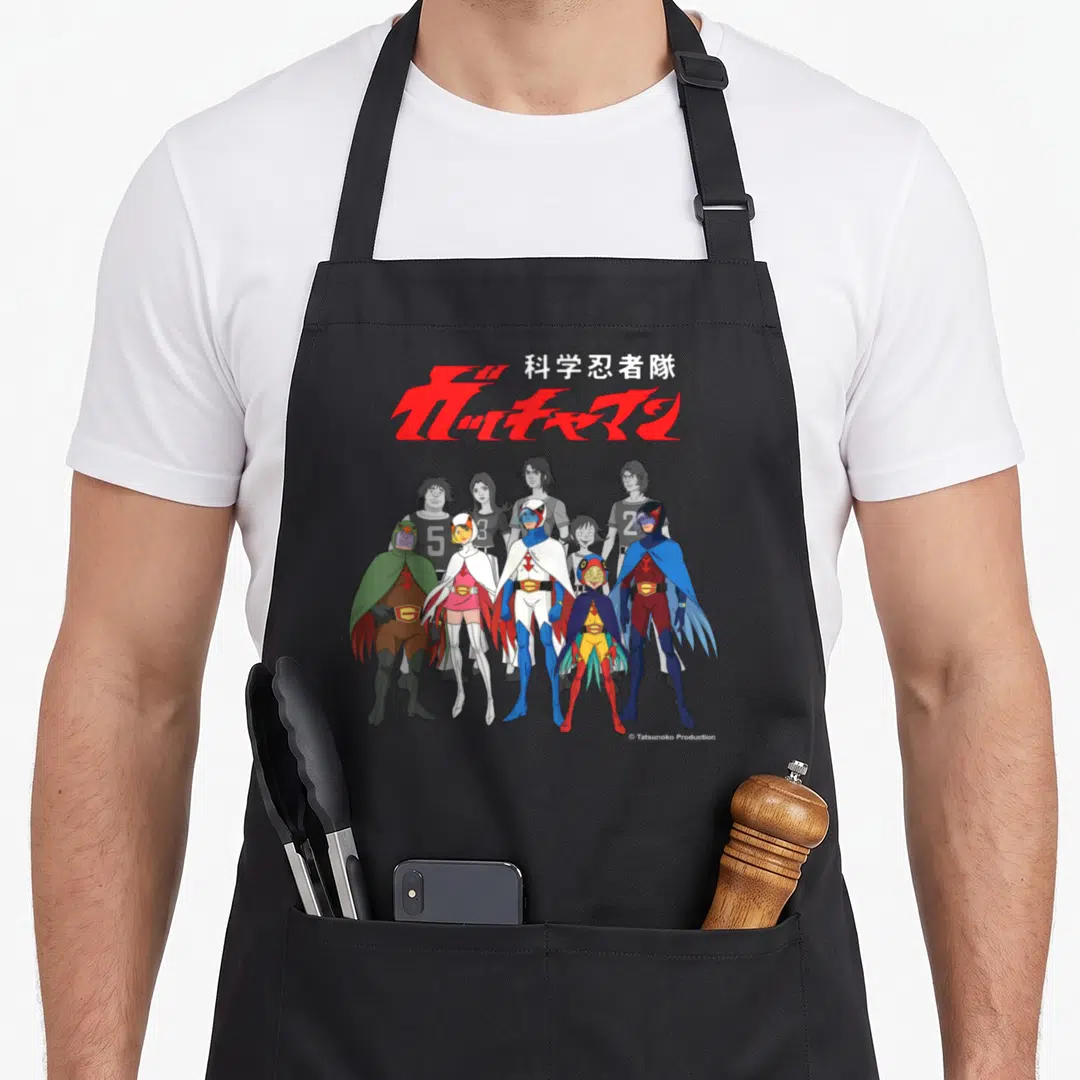 Manga line apron - Gatchaman logo with five heroes standing in colored costumes behind grey figures — shown on a black cotton canvas apron against a white background