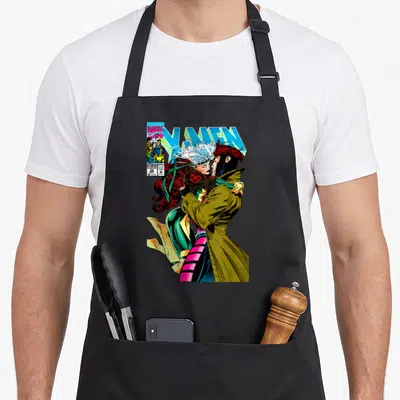 Gambit couple apron - Comic cover art of couple kissing with X-Men title and Marvel logo — shown on a black cotton canvas apron against a white background