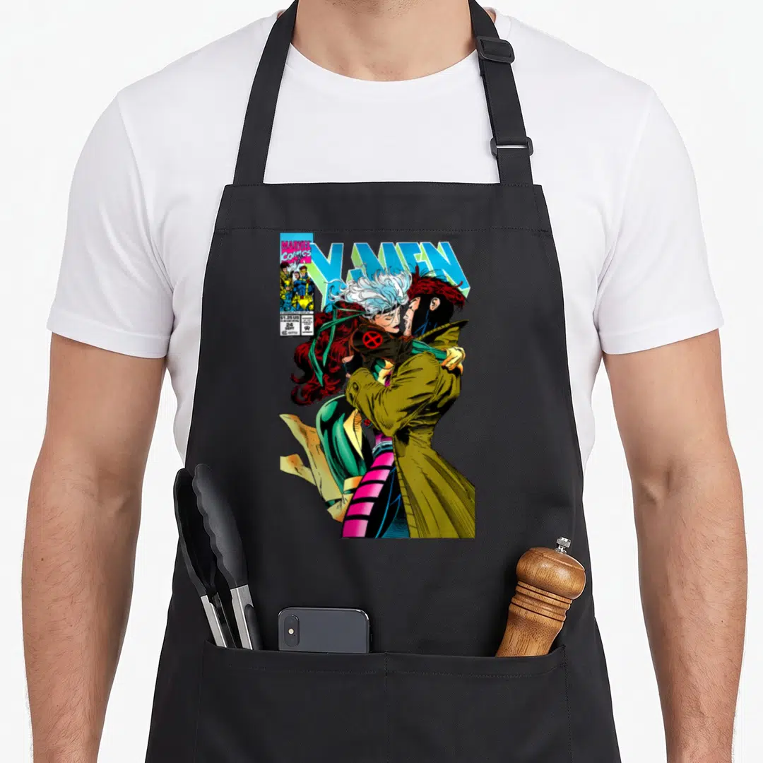 Gambit couple apron - Comic cover art of couple kissing with X-Men title and Marvel logo — shown on a black cotton canvas apron against a white background