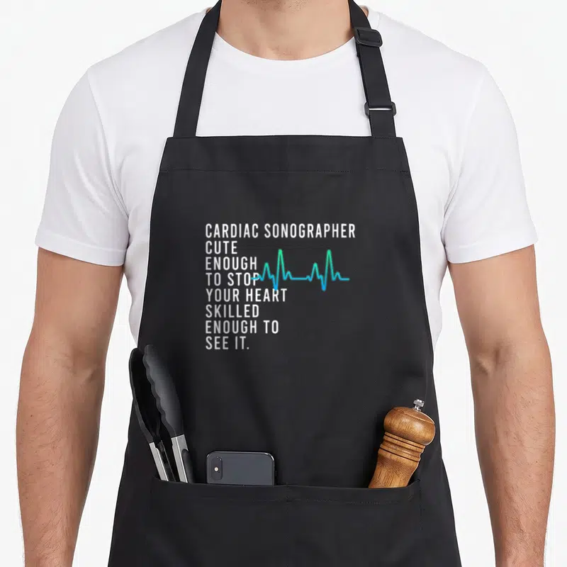 Cardiac tech mom apron - Stacked white text reading cardiac sonographer cute enough to stop your heart skilled enough — shown on a black cotton canvas apron against a white background