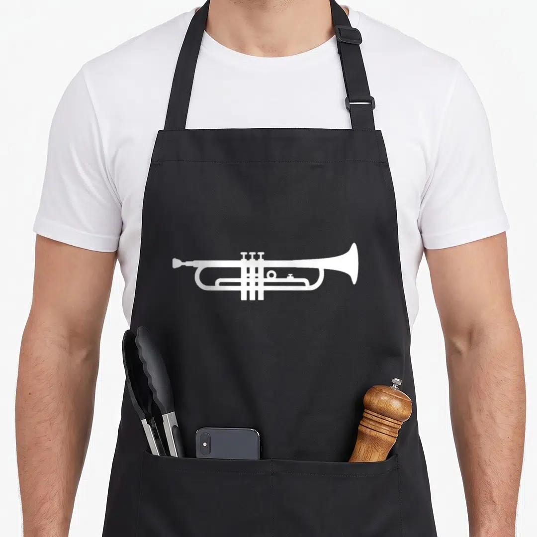 Funny trumpet apron - Minimalist white trumpet silhouette centered on grey background — shown on a black cotton canvas apron against a white background