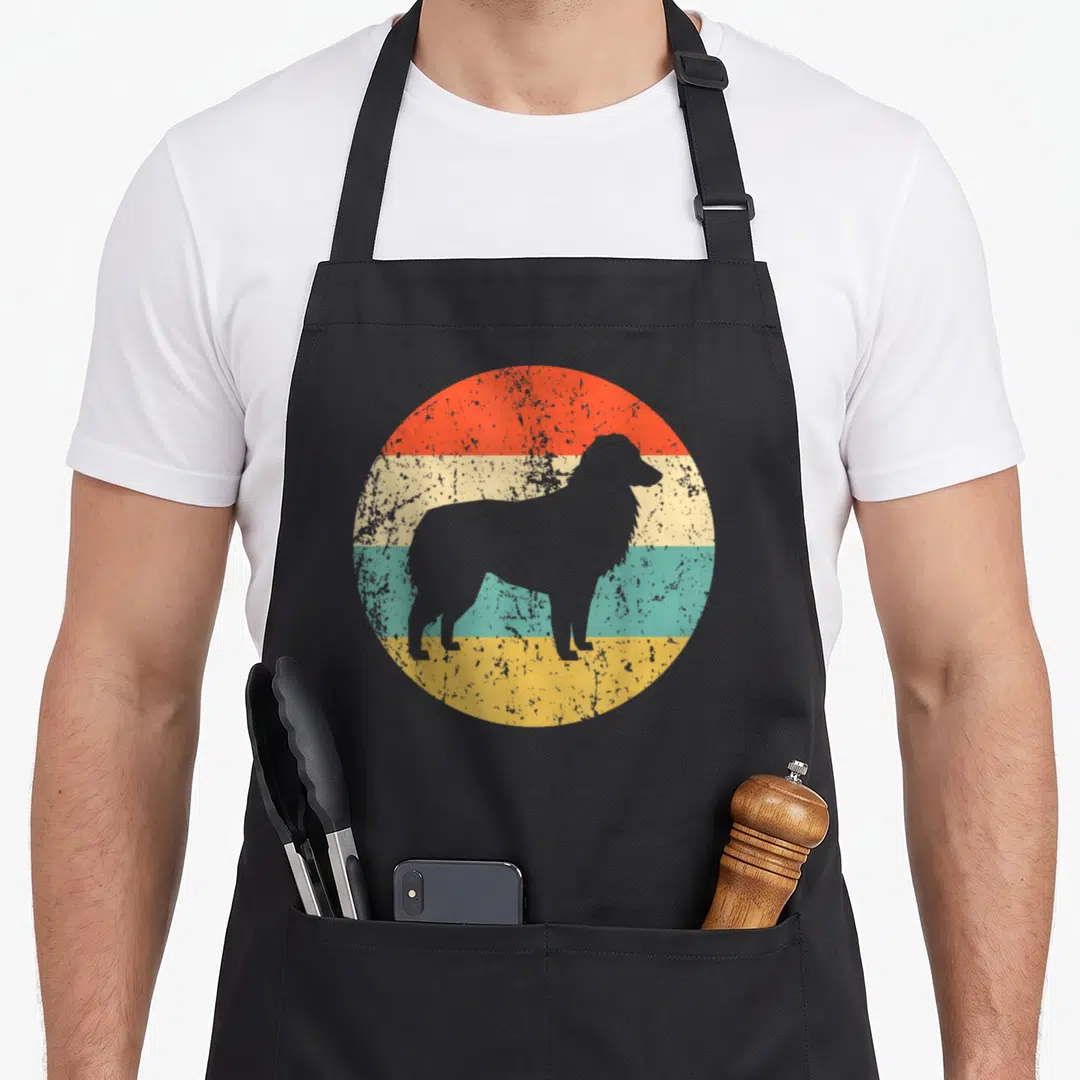 Shepherd aussie dog australian aprons - Grey dog silhouette over four colored stripes with distressed texture — shown on a black cotton canvas apron against a white background