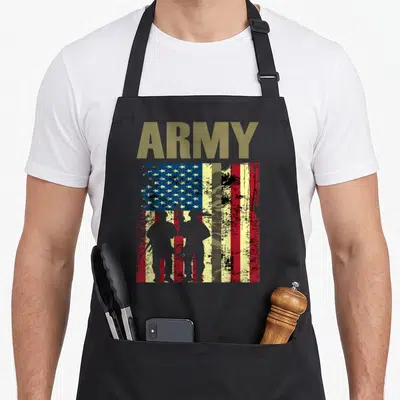 Army camo aprons - Distressed USA flag with ARMY text, two soldier silhouettes, and central camo stripe in olive grey — shown on a black cotton canvas apron against a white background